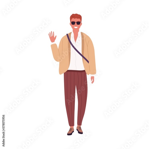 Stylish guy in sunglasses smiling waving hand vector flat illustration. Modern young businessman or student in trendy clothes isolated on white. Casual male standing in fashionable outfit