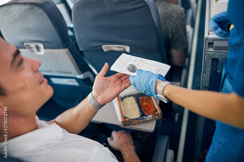 Passenger eating food on board the commercial plane