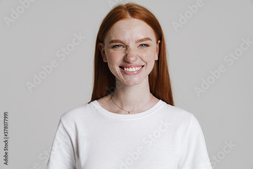 Image of happy ginger girl smiling and grimacing at camera