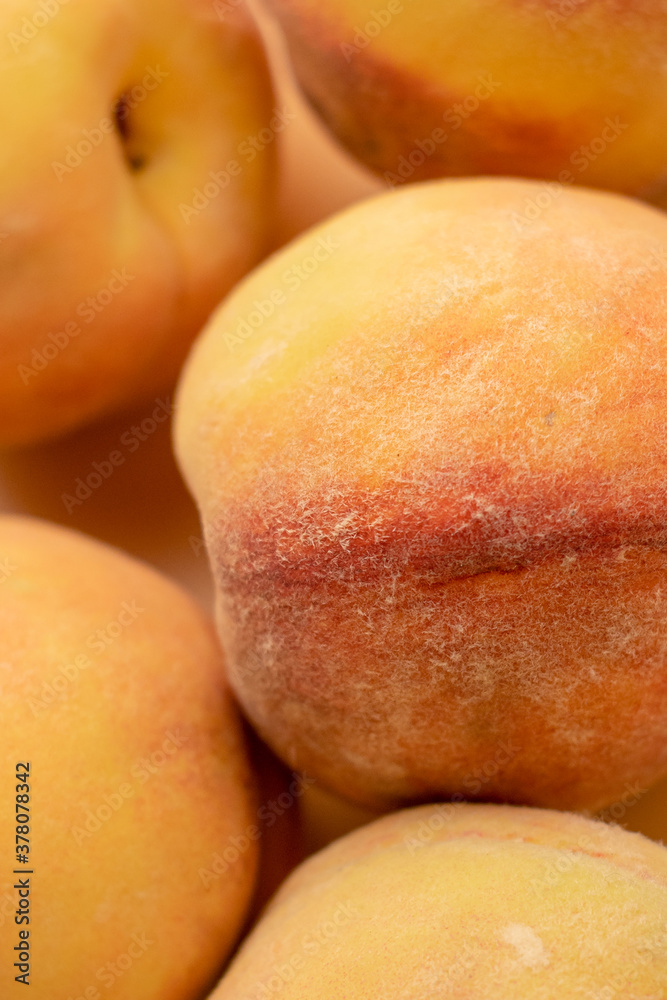Three yellow peaches on a beige background . The view from the top. Three yellow peaches on a beige background . The view from the top.