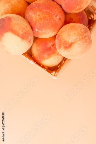 Three yellow peaches on a beige background . The view from the top. photo