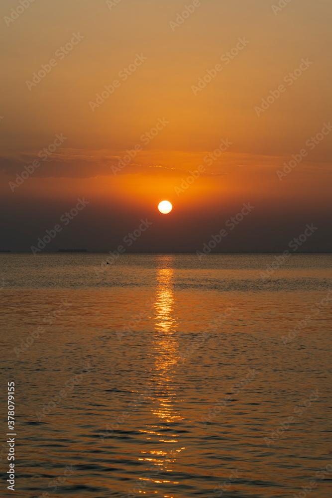 Glowing orange Sunset over private beach area in the Eastern Province of Saudi Arabia 