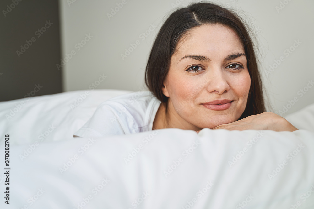 Smiling calm woman gazing in front of her Smiling calm woman gazing in front of her