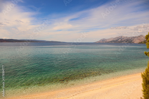 Fototapeta Naklejka Na Ścianę i Meble -  Picturesque panorama of the Croatian sea coast, view of the turquoise blue transparent sea and the beach on a hot summer day