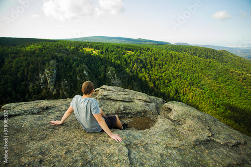 Man sitting on rock, beautiful nature view, czech republic