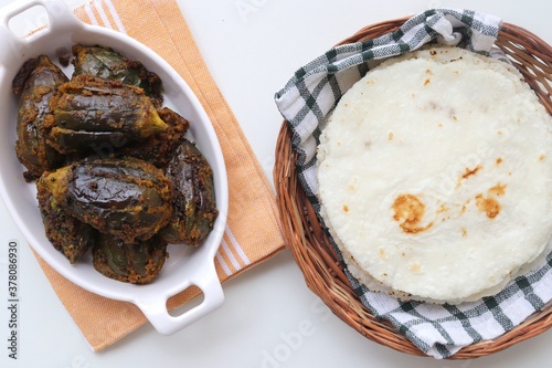 Indian, Maharashtrian side dish or appetizer Bharli Vangi, stuffed Eggplants, Crispy brinjal fry, Aubergine stuffed, served with Rice flour bhakri. copy space photo