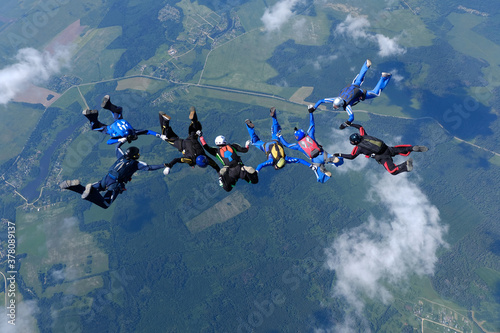 Skydiving. Skydivers are training in the sky.