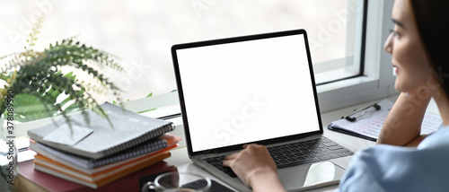 Fotografie Close up of bussinesswoman use laptop with white screen for planing on office desk
