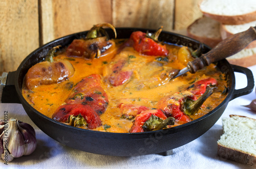 Sweet peppers in tomato and sour cream sauce, a traditional dish in some European countries. Rustic style.