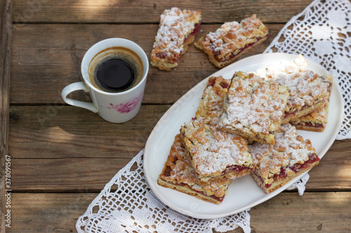 Streusel pie stuffed with rose jam  served with coffee. Rustic style.