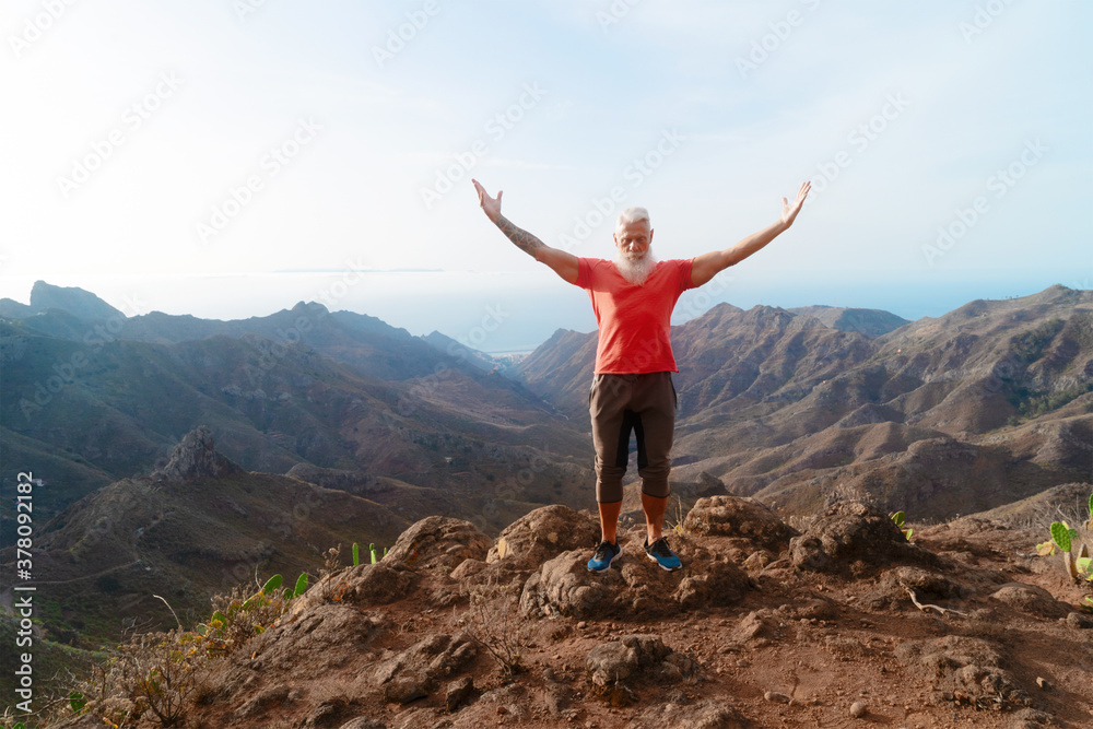 Senior man greeting sunset