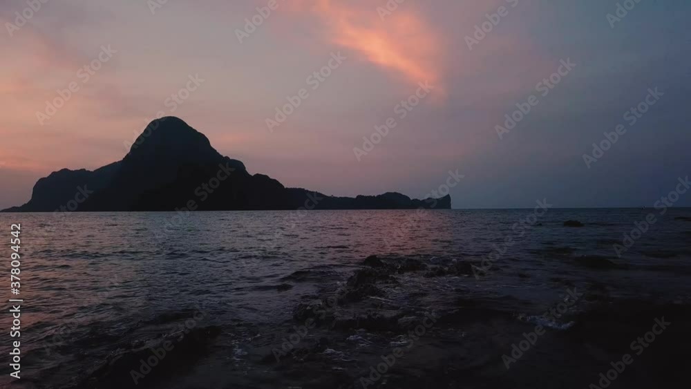 Beautiful sunset in El Nido, The Philippines over the mountains and the ocean Beautiful sunset in El Nido, The Philippines over the mountains and the ocean