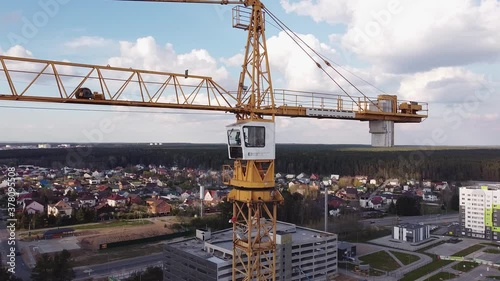 Aerial view of on construction site industrial tower crane. Crane work with the city In the Background. Newbor district photo