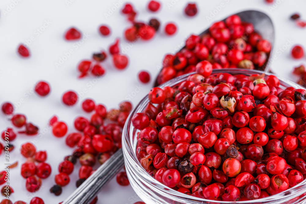 fragrant pink peppercorns on white acrylic background fragrant pink peppercorns on white acrylic background