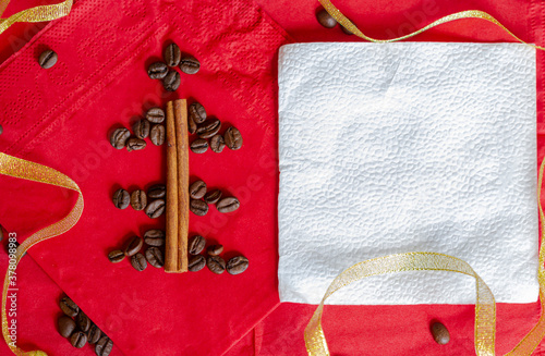 Red and gold Christmas background with coffee and cinnamon sticks new year lovely drink and food