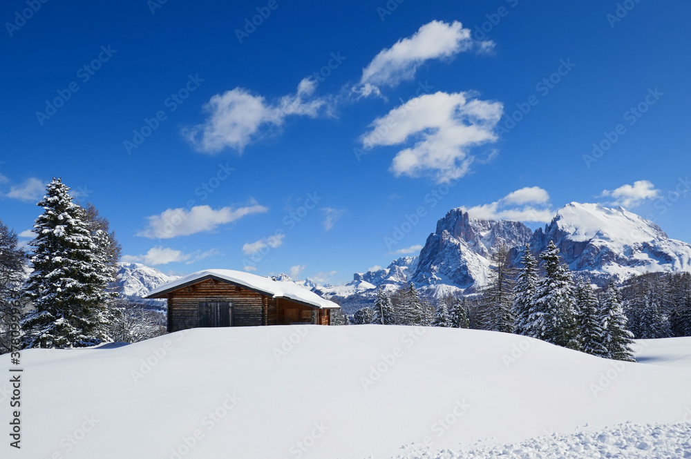 Lonely house in dolomites on a sunny winter day