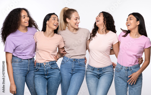 Happy Multiethnic Women Hugging Laughing Standing Together Over White Background
