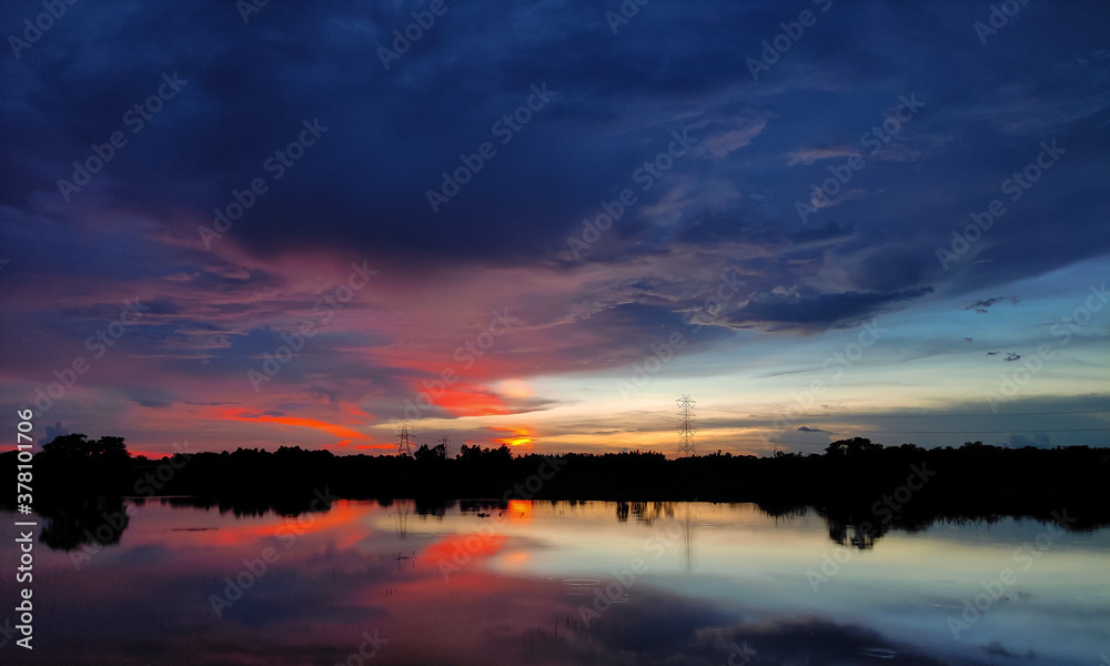 During sunset, black clouds are slowly covering the sky. During sunset, black clouds are slowly covering the sky.