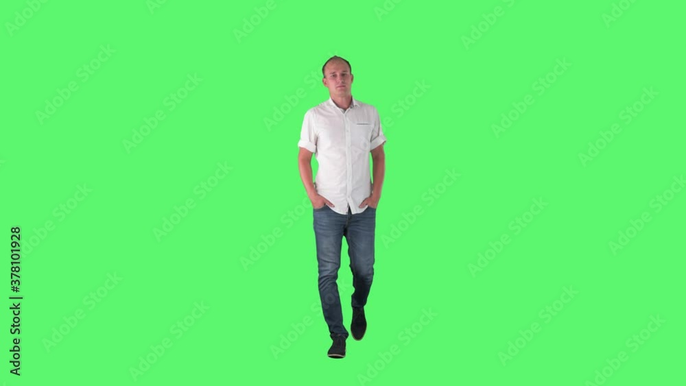 Successful confident business man walking and looking at camera with hands in pockets. Full body on green screen. Successful confident business man walking and looking at camera with hands in pockets. Full body on green screen.