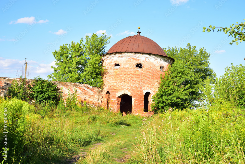 Ruins of a round watch tower. The tower is adjacent to the fortress wall. The fortress in the Turkish style, built in the 18th century by Count M.F. Kamenskikh in his estate Saburovo.
