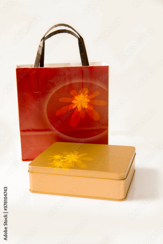 Golden gift box with red handbag on white background Golden gift box with red handbag on white background