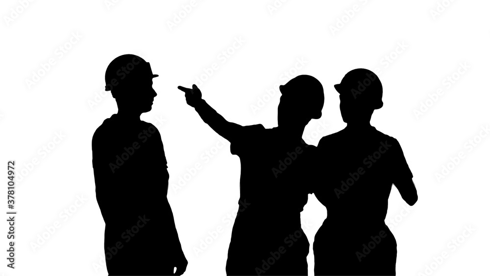 Silhouette Three male construction workers in hardhats looking a