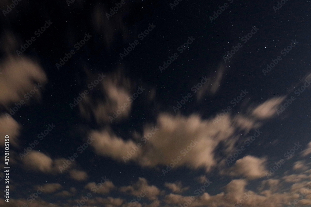 Night sky with clouds and stars. Can be used as a design element, background