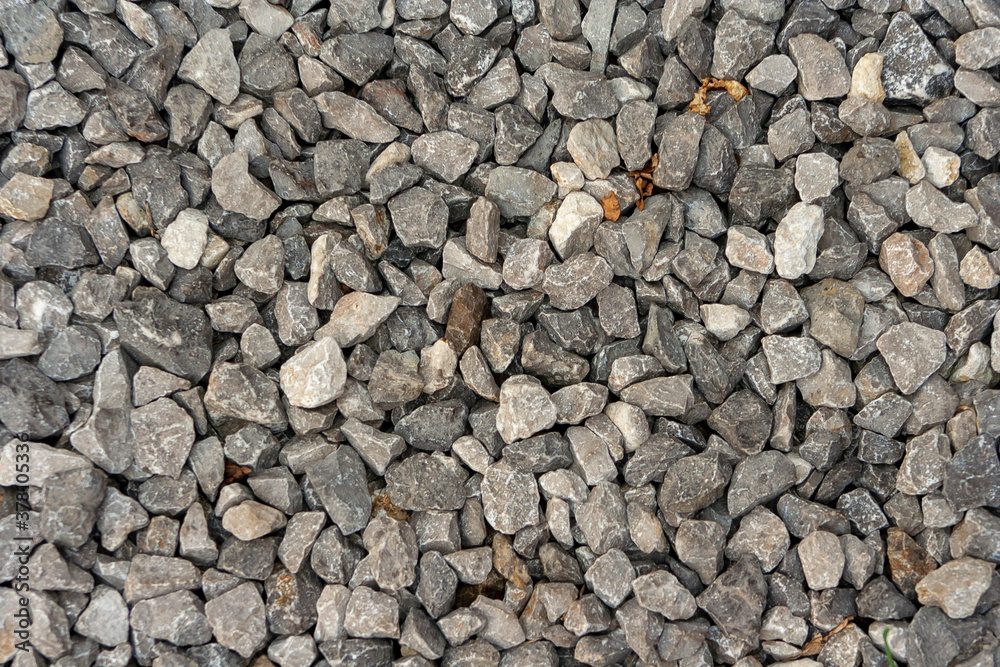 small road stone background, dark gravel pebbles stone texture. Closeup top view gravel. Gravel in garden. Pattern small road stone background, dark gravel pebbles stone texture. Closeup top view gravel. Gravel in garden. Pattern