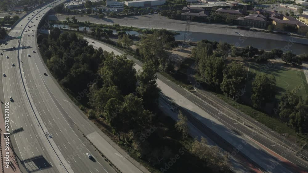 Aerial View of Light Evening Traffic on Interstate 5 Freeway Intersection with the CA State Route 134, Los Angeles, From Griffith Park to Burbank Above the LA River Rising Towards Mountains in Covid