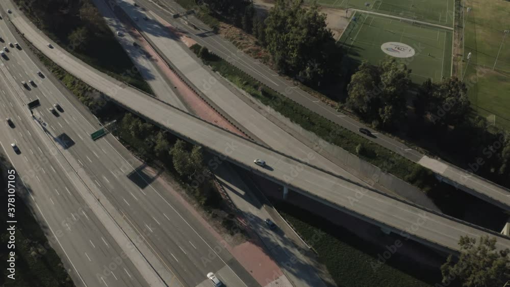 Los Angeles, California USA, Birdseye Aerial View of Traffic on the I-5 Golden Interstate Freeway on Sunny Evening During Covid-19 Virus Outbreak, Drone Shot Tracking Main Intersection of Highways
