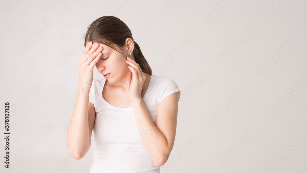 Tired woman feeling pain, massaging tense muscles Tired woman feeling pain, massaging tense muscles