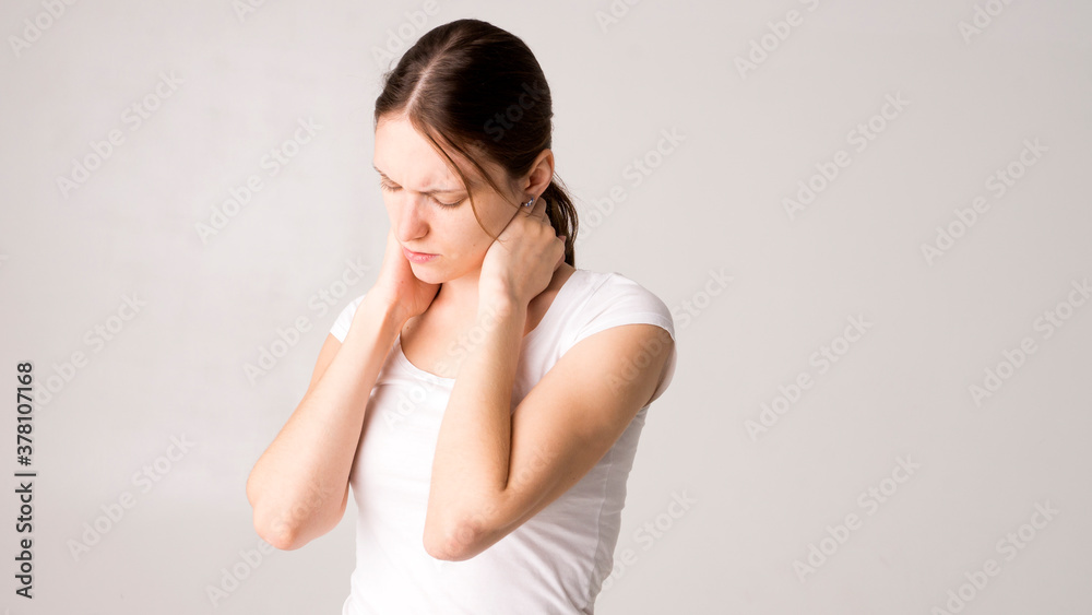 Tired woman feeling pain, massaging tense muscles Tired woman feeling pain, massaging tense muscles