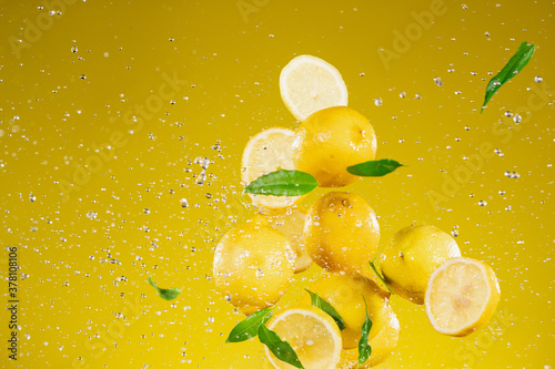 Fresh ripe lemons flying on...