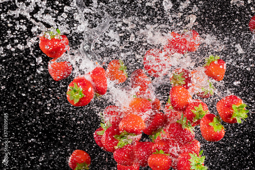 Fresh ripe strawberries fly...