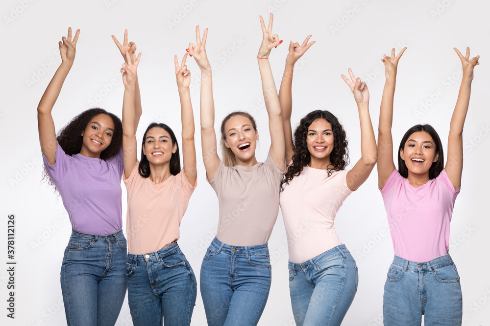 Group Of Ladies Gesturing V-Sign Standing Over White Studio Background Group Of Ladies Gesturing V-Sign Standing Over White Studio Background
