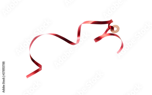A thin curly red ribbon for Christmas and birthday present tag loop isolated against a white background.