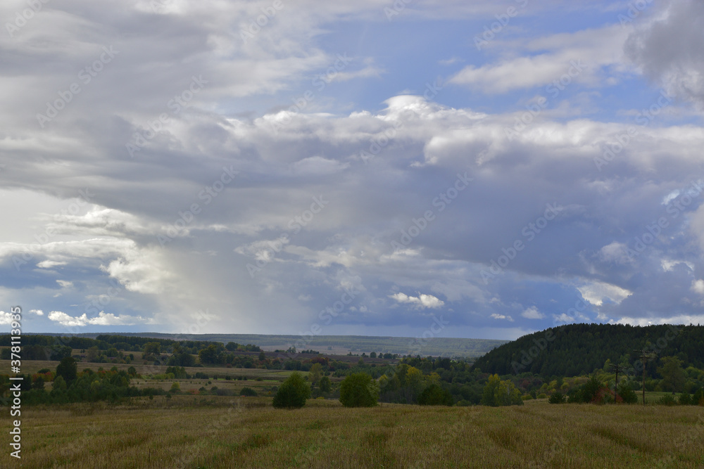 Cold rains over village fields and copses. Autumn bad weather in the foothills of the Western Urals.