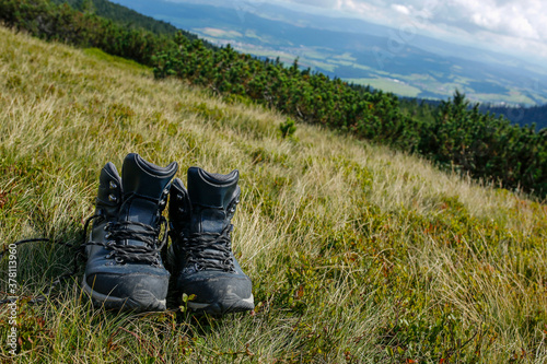 Fototapeta Naklejka Na Ścianę i Meble -  hiker boots on the mountain meadow