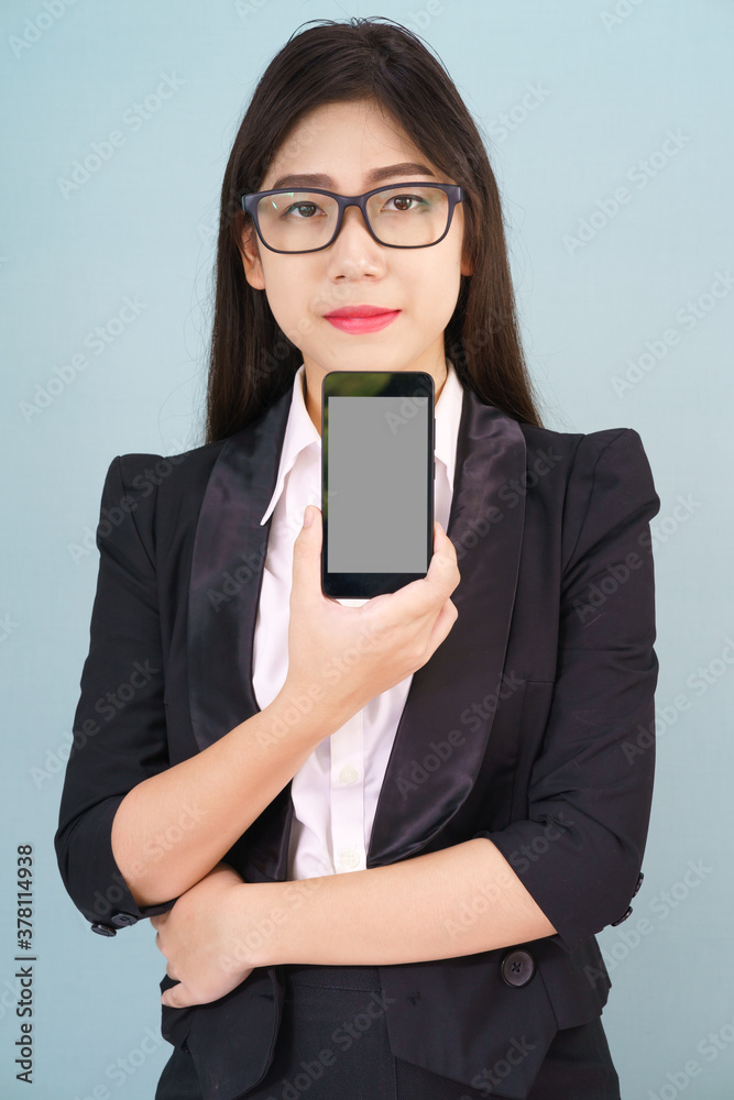 Fototapeta premium Young women in suit holding her smartphone