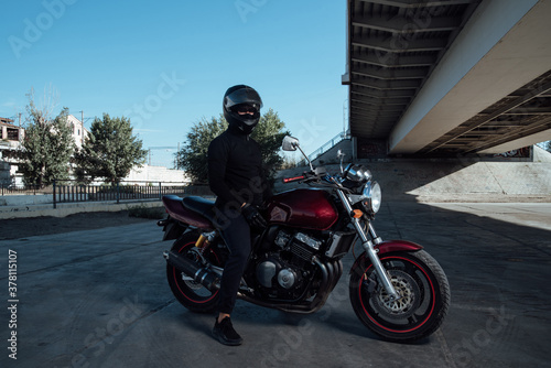 Man seat on the motorcycle.Motorcyclist in black helmet on a red bike