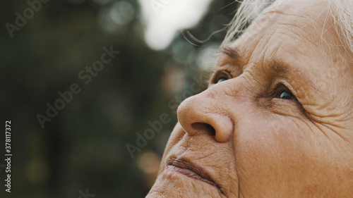 Eyes of elderly woman in the park. looking up in the sky. Extreme close up. High quality photo photo