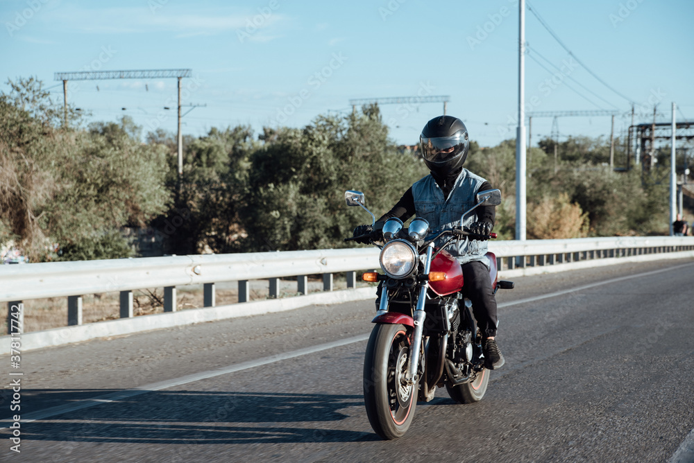 Man rides a motorcycle in the city.Motorcyclist riding a bike during the day on the road
