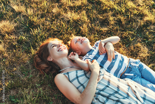 Happy family: mother and son in nature in summer. photo