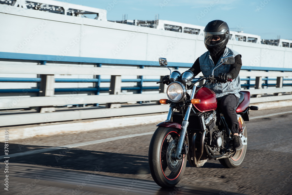 Man rides a motorcycle in the city.Motorcyclist riding a bike during the day on the road Man rides a motorcycle in the city.Motorcyclist riding a bike during the day on the road