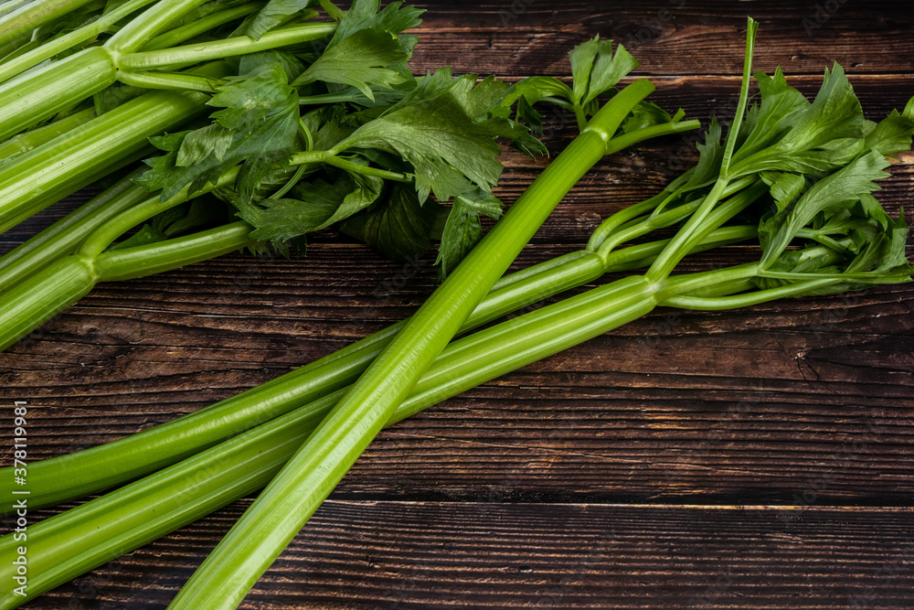 Bunch of fresh celery stalk with leaves on wooden background. Bunch of fresh celery stalk with leaves on wooden background.