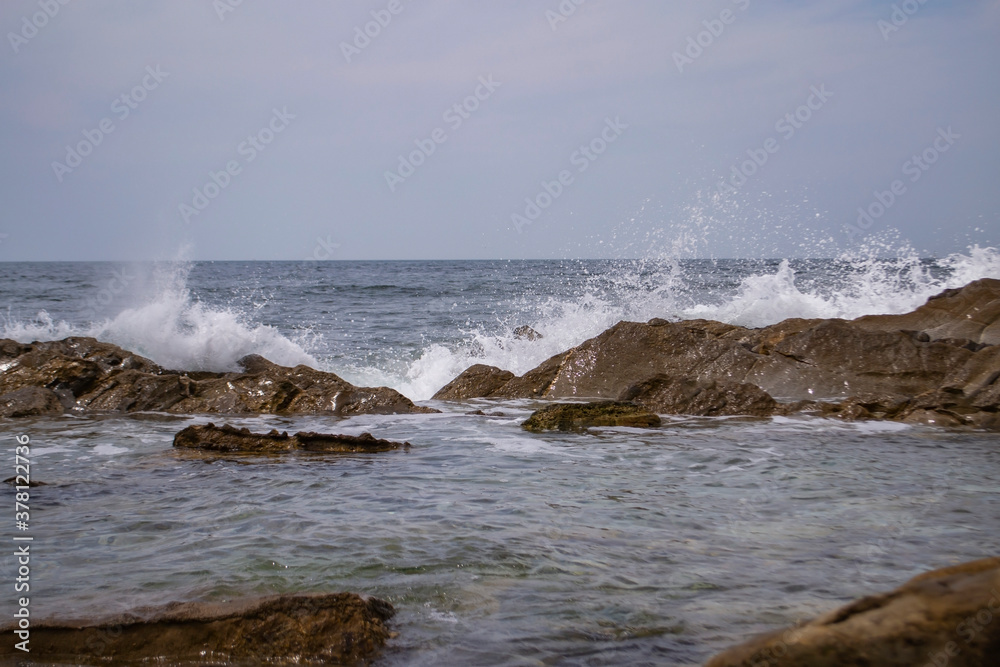 waves crash on stones