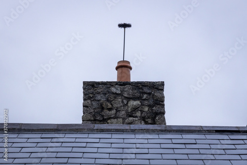 Chimney Cleaning Brush Sticking Up Out of a Chimney Pot - Straight On