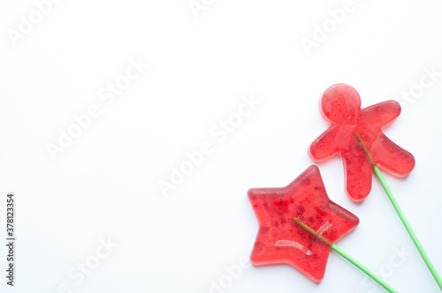 Lollipops on a white background. Gingerbread man and star. Christmas concept. Copy space.Flat lay.
