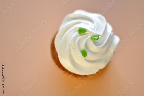 Cupcake decorated by cream meringue and sweet Christmas tree, dessert for party, birthday, new year eve, festive