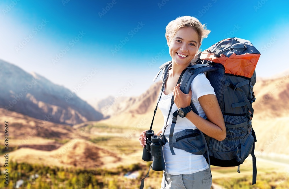 Travels female happy and smiling during a hike